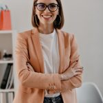 close-up-portrait-smiling-short-haired-business-woman-white-t-shirt-posing-with-arms-crossed-white-office_197531-10725